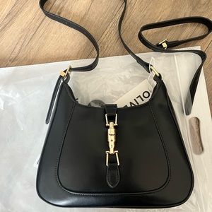 Black over the shoulder purse from the brand Olives.